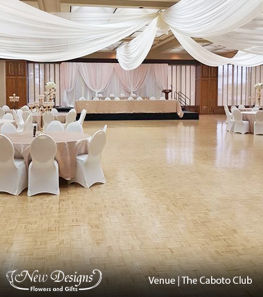A gorgeous hall in whites, and soft blush table cloths. With gold and crystal 5 posted orb candelabras.